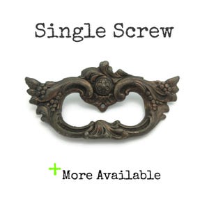 May include: Ornate, antique-style bronze drawer pull with a decorative floral and scroll design. The words "Single Screw" are printed above the pull, and "More Available" is printed below.