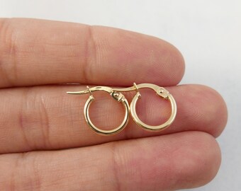 May include: A pair of small, gold hoop earrings. The earrings are simple and elegant, and they would make a great gift for any occasion.
