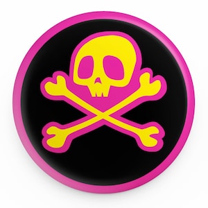 May include: A pink and yellow skull and crossbones design on a black background. The design is on a round button.