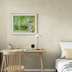 May include: A framed painting of a person walking through a forest. The painting is in a light wood frame and is hanging on a light beige wall.