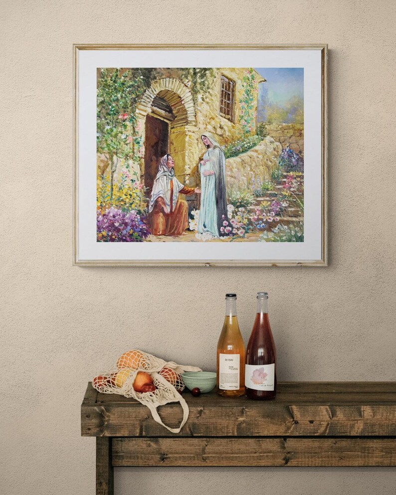 May include: A framed painting depicts a biblical scene with two figures in front of a stone building with an arched doorway. Below, a wooden table displays two wine bottles, a string bag with fruit, and a small bowl.