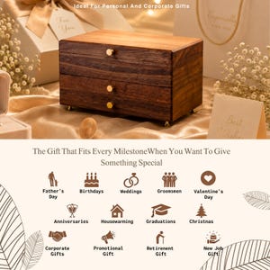 May include: A wooden jewelry box with three drawers and gold-colored knobs. The box is made of dark brown wood and sits on small gold feet. Text on the image reads "The Gift That Fits Every Milestone When You Want To Give Something Special."