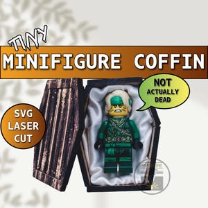 May include: A Lego minifigure in a tiny wooden coffin. The coffin is open, revealing the green and black minifigure resting on a white satin lining. Text on the image reads "TINY MINIFIGURE COFFIN" and "NOT ACTUALLY DEAD".