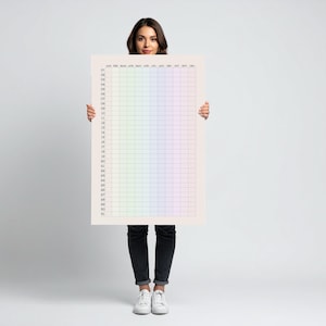 May include: A large, rectangular planner with a grid design and pastel rainbow gradient. The top of the planner has the months of the year, and the left side has numbers 01-31. The planner is held by a person.