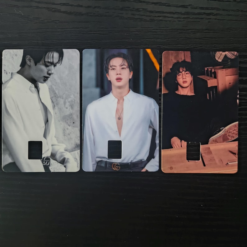 May include: Three rectangular cards featuring images of a person in different poses. The cards have a cutout at the bottom. The person is wearing a white shirt in two of the images and a black shirt in the third image.