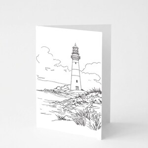 May include: A black and white line drawing of a lighthouse on a greeting card. The lighthouse is tall and cylindrical, with a light at the top. It is situated on a rocky shoreline with grass and clouds in the background.
