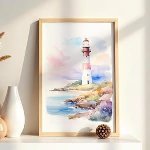 May include: Watercolor painting of a lighthouse on a rocky coastline. The lighthouse is white and red, set against a backdrop of a colorful sky and ocean. The artwork is framed in a light wood frame.
