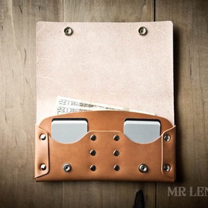 May include: A brown leather wallet with two card slots and a cash pocket. The wallet is open and has cash and cards inside.