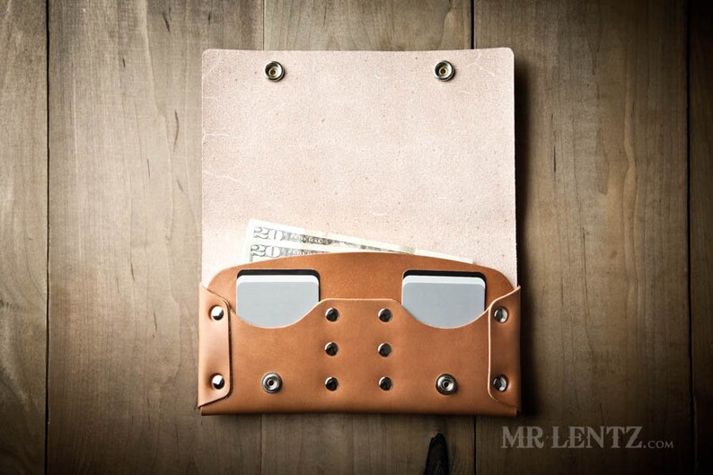 May include: A brown leather wallet with two card slots and a cash pocket. The wallet is open and has cash and cards inside.