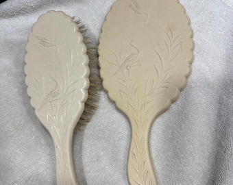 vintage celluloid hand mirror and brush with crane motif