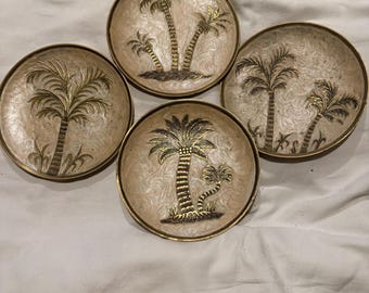 vintage-style plates are made from solid brass with an enamel palm tree design