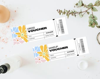 Może przedstawiać: Dwa białe vouchery z kwiatowymi wzorami w kolorze żółtym, niebieskim i różowym. Jeden głosi "DRESS VOUCHER", a drugi "MAKEUP VOUCHER". Oba mają datę i kod kreskowy. Tło zawiera produkty kosmetyczne i zieleń.