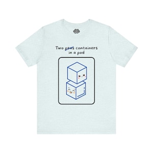 May include: Pale blue t-shirt with the phrase "Two peas containers in a pod." The graphic shows two blue cube-shaped containers with smiling faces, stacked within a black rectangle.
