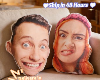 May include: Two custom face pillows with expressive facial expressions. One pillow features a smiling man with wide eyes, the other a woman with a grimace. The pillows are on a beige couch.