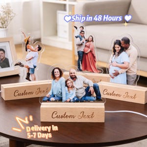 May include: Acrylic photo displays with custom text on wooden bases. The images feature families and couples, some pregnant. The text "Custom Text" is engraved on the wooden bases. The image also includes the text "Ship in 48 Hours" and "Delivery In 5-7 Days".