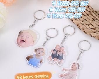 May include: A collection of personalized keychains featuring photos of babies. Each keychain has a silver ring and chain. The image also includes text that says "48 hours shipping" and "2 items 60% OFF, 3 items 65% OFF, 4 items 70% OFF, 5 items 75% OFF."