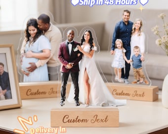 May include: Acrylic photo cutouts of couples and families, mounted on wooden bases. The cutouts feature images of a pregnant couple, a wedding couple, and a family with two children. The text "Custom Text" is engraved on the wooden bases.
