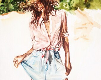 Frau mit Strohhut am Strand