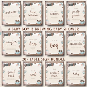 May include: A collection of watercolor baby shower signs with a coffee theme. Signs include phrases like "Welcome," "Baby Time Capsule," and "It's a Boy." The signs are in wooden frames with baby-themed illustrations.