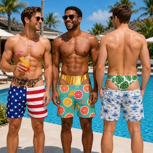 May include: Three pairs of swim trunks. The first pair features a red, white, and blue American flag pattern with a leopard print waistband. The second pair has a teal background with orange citrus slices and a gold waistband. The third pair has a white and blue palm tree print with a green leaf print waistband.