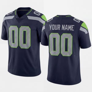 May include: A navy blue sports jersey featuring the number 00 in grey with a lime green outline on the front and back. The back displays the text YOUR NAME in grey lettering. The shoulders have grey and lime green accents on the sleeves.