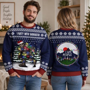 May include: A navy blue long-sleeve crewneck sweatshirt featuring a white snowflake pattern and a graphic of a Sasquatch wearing a Santa hat wrapped in colorful Christmas lights with the text I PARTY WITH SASQUATCH and I HATE PEOPLE.