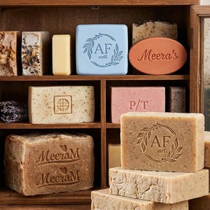 May include: A set of three ceramic mugs with a speckled, matte finish. The mugs are in shades of cream, light gray, and dark gray. Each mug has a simple, minimalist design, perfect for coffee or tea.