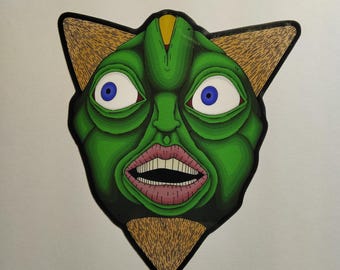 Puede incluir: Una cara verde de dibujos animados con grandes ojos azules y boca abierta, sobre un fondo blanco. La cara tiene forma de gato con orejas color canela y contorno negro. Los labios son rosas y los dientes blancos.