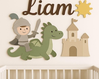 May include: A whimsical wall decoration featuring a knight riding a green dragon, a castle, and a yellow sun. The name "Liam" is written in brown script. The scene is set against a white background, perfect for a nursery or child's room.