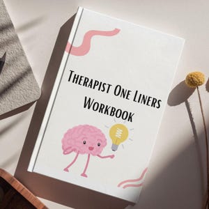 May include: A white workbook titled "Therapist One Liners Workbook" with a pink brain character holding a yellow lightbulb. The cover has pink decorative lines. The workbook is on a light-colored surface.