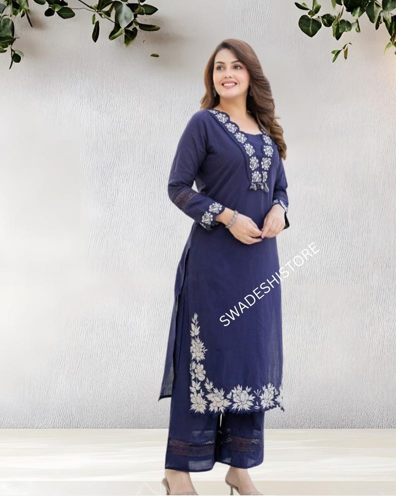 May include: A navy blue embroidered kurta and palazzo set. The long-sleeved kurta features white floral embroidery along the neckline, cuffs, and side slit. The palazzo pants have matching embroidery at the hem. The text "SWADESHI STORE" is visible.