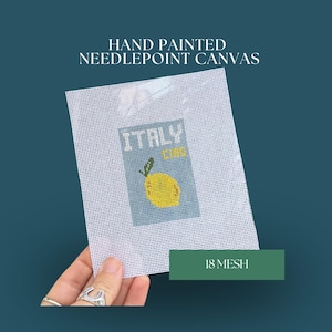 May include: Hand-painted needlepoint canvas featuring a design with the word "Italy" and a yellow lemon. The canvas has a white mesh background and the text "18 Mesh" is visible.