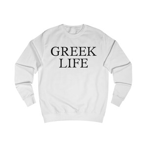 May include: White sweatshirt featuring the black text "GREEK LIFE" across the chest. The crew neck top has long sleeves and is made of a soft fabric.