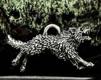May include: A silver wolf pendant in a running pose, with detailed fur and an open mouth. The pendant has a loop for a chain. The background is a textured, dark green and brown.