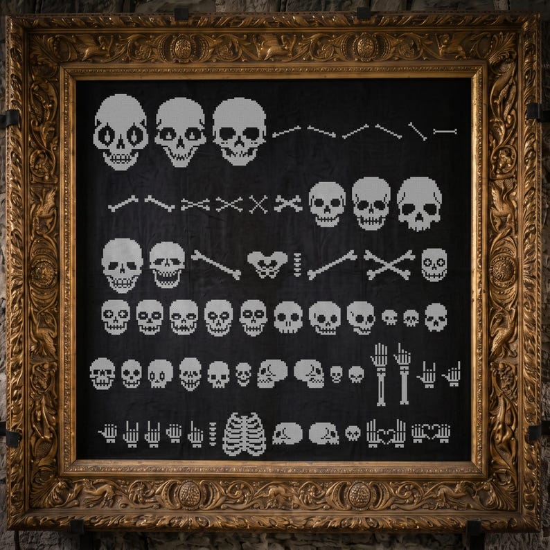May include: A black fabric piece featuring a white pixel art pattern of various human skulls, bones, hands, and a rib cage, displayed within an ornate, rectangular, metallic gold-colored frame with intricate relief carvings.