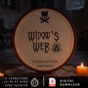 May include: A circular wooden embroidery hoop containing a cross stitch pattern on off-white fabric. The design features a black spider icon, the text "WIDOW'S WEB", and the words "cross stitch pattern" in black. Text below includes "79 CHARACTERS", "25-36 ST HIGH", "AIDA 14/16/18", and "DIGITAL DOWNLOAD".