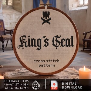 May include: A circular wooden embroidery hoop containing a cross-stitch pattern on off-white fabric. The design features a black crown icon above the text King's Seal and the words cross stitch pattern. Text at the bottom includes 80 characters, 40-47 st high, Aida 14/16/18, and digital download.