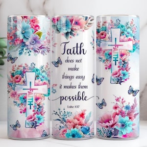 May include: Three cylindrical tumblers with floral and butterfly designs. Each tumbler features a cross and the text "Faith does not make things easy, it makes them possible" from Luke 1:37. The floral arrangements include pink, blue, and purple flowers.
