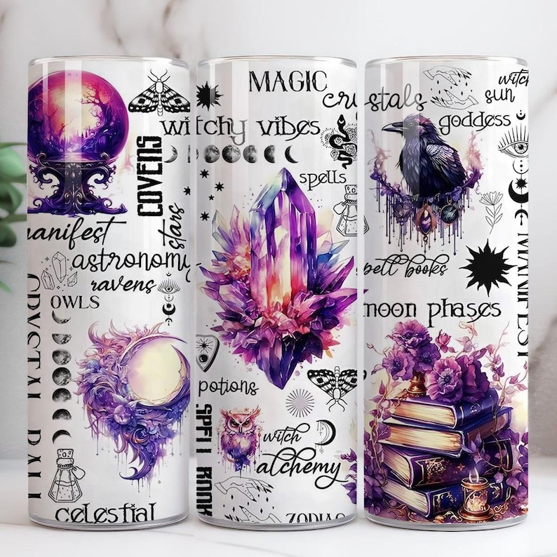 May include: Three white tumblers with celestial, witchy, and magical designs. The first tumbler features a purple crystal ball, the second a large purple crystal, and the third a raven perched on a branch. Text includes "manifest", "magic", and "crystals".