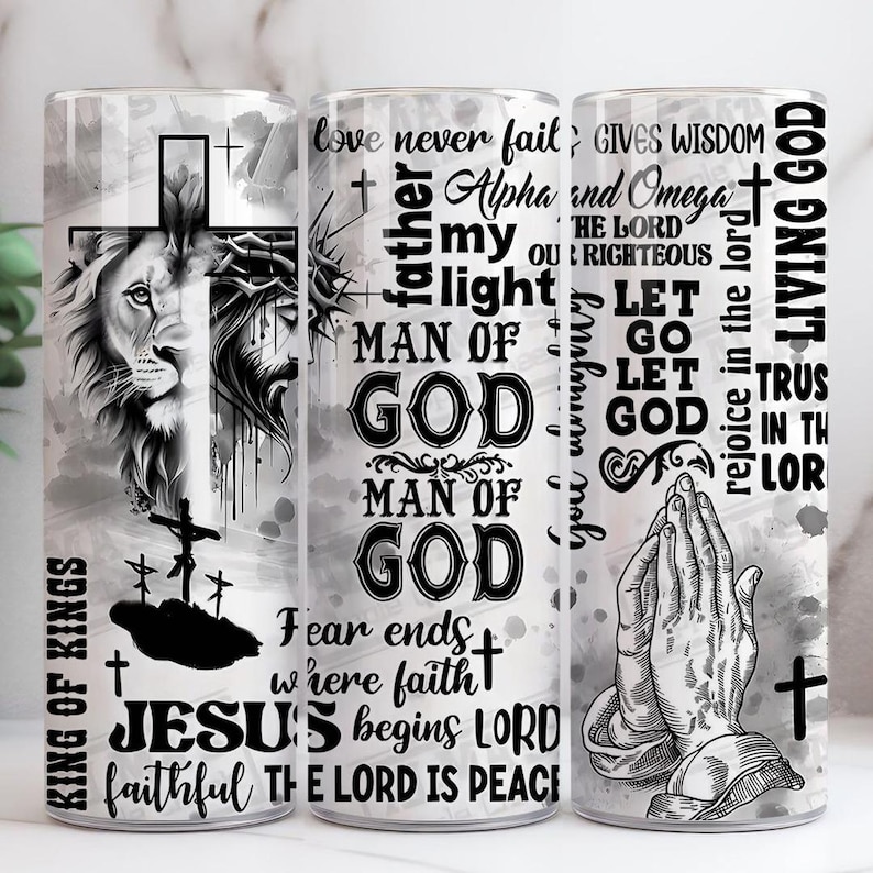 May include: Three tall, cylindrical tumblers with religious themes. One features a lion's head and cross, another has text including "Man of God", and the third shows praying hands. The tumblers are decorated with black and white graphics and text.