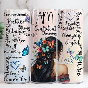 May include: Three stainless steel tumblers with motivational words and butterfly illustrations. The tumblers display words such as "Compassionate", "Confident", and "Beautiful". The design includes a woman's silhouette and colourful butterflies.