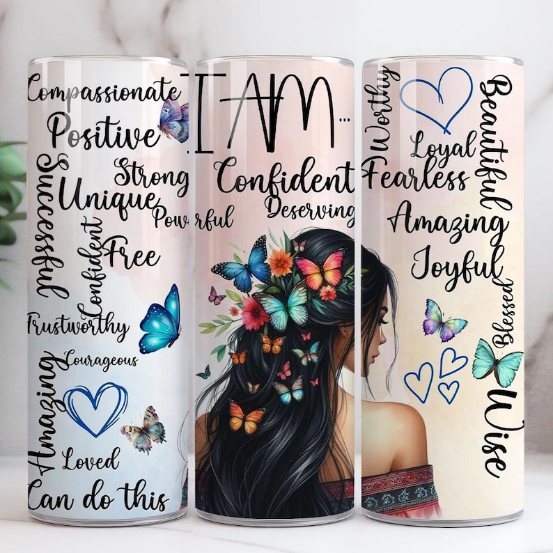 May include: Three stainless steel tumblers with motivational words and butterfly illustrations. The tumblers display words such as "Compassionate", "Confident", and "Beautiful". The design includes a woman's silhouette and colourful butterflies.