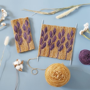 May include: A flat lay of knitting supplies, including two pieces of knitted fabric with a purple leaf design, two balls of yarn, one in purple and one in a light brown color, and dried flowers.