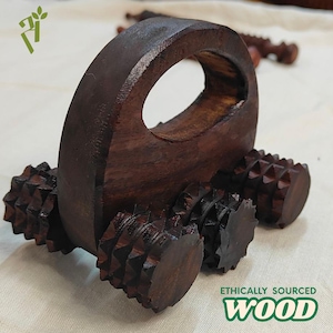 May include: A dark brown wooden massage roller with a handle and textured rollers. The product is made of ethically sourced wood. The rollers are designed to provide a deep tissue massage.