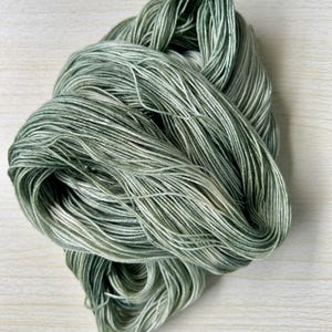 Hand Dyed Light Fingering yarn - Green variegated with hints of speckles  (Matcha latte color way) - 100g - ready to ship