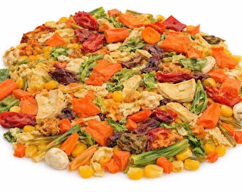 May include: A colorful assortment of dried vegetables, including orange carrots, green beans, and red tomatoes. The mix also contains corn kernels and other dehydrated ingredients. The image is a close-up shot of the food, showcasing the variety of textures and colors.