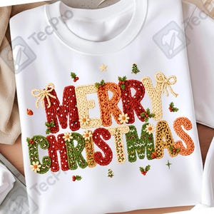 May include: White crew neck t-shirt featuring the text "MERRY CHRISTMAS" in a colourful, textured design. The letters are decorated with knitted patterns, floral accents, and festive embellishments, ideal for the Christmas holiday.