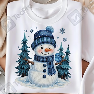 May include: White sweatshirt with a charming snowman illustration. The snowman is adorned with a blue hat and scarf, and has a carrot nose. A blue bird perches on a branch, with fir trees and snowflakes completing the winter scene.