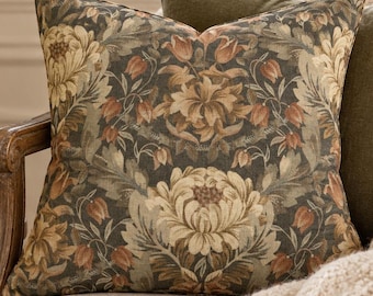 May include: A square throw pillow featuring a dark charcoal background with a repeating botanical pattern of large cream-colored chrysanthemums and smaller orange-toned tulip-like flowers with green foliage, finished with a piped edge.