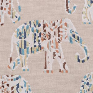 May include: A beige fabric with a repeating pattern of colourful elephants. The elephants are stylised and have a geometric design with blue, orange and yellow accents.